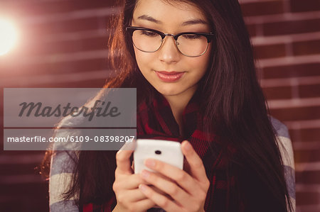 Attractive hipster holding her smartphone
