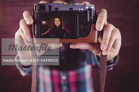 Attractive smiling hipster doing a selfie