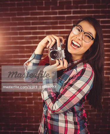 Attractive hipster holding a camera