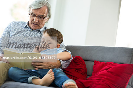 Grandfather and grandson reading a book