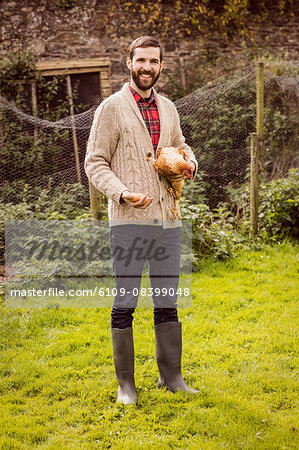 Man holding chicken and egg