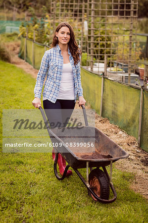 Woman pushing a wheelbarrow