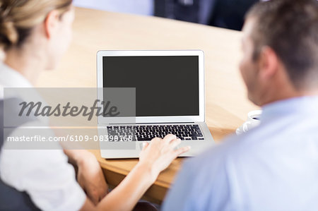 Business people working together while using laptop