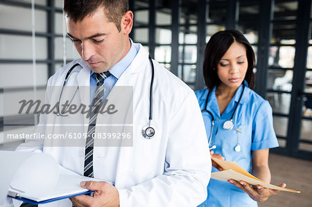 Nurse and doctor looking at files