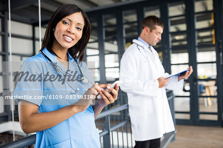 Nurse and doctor looking at phone and file