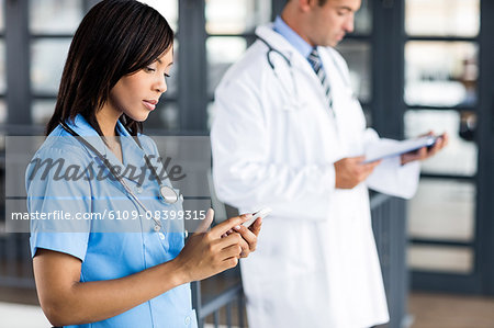 Nurse and doctor looking at phone and files