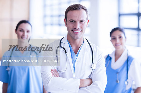 Smiling medical team with arms crossed