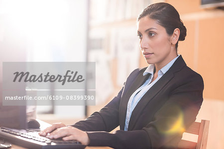 Serious businesswoman working at her desk