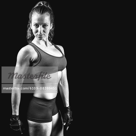 Composite image of portrait of sporty woman with gloves