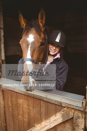 Pretty woman hugging her horse