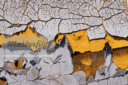 Detail of peeling and cracked paint on an old silo wall.