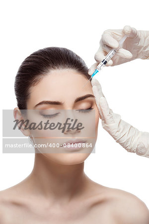 Beautiful young woman gets beauty injection in forehead from sergeant. Isolated over white background.
