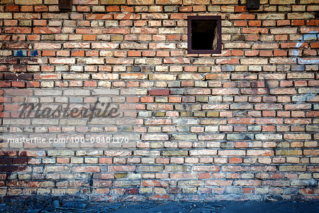 Yellow brick wall with one small window