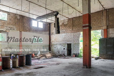 Interior of an abandoned cellar with details of wear and tear by time. You can see flashes of sunlight that enter through gaps and windows.