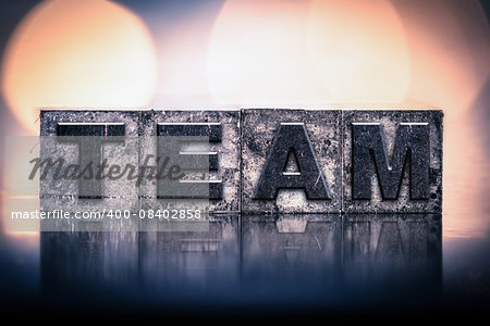 The word "TEAM" written in vintage ink stained letterpress type.