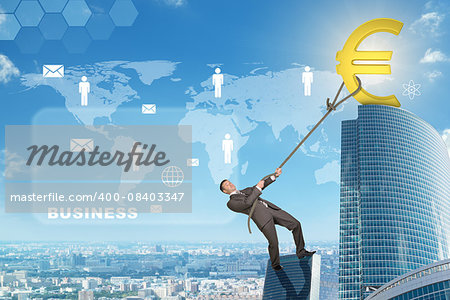 Businessman climbing skyscraper holding golden euro sign