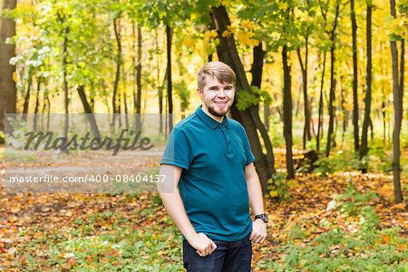 Young smiling man portrait  in autumn park. Outdoor.