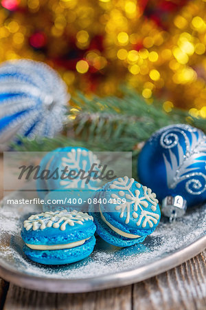 Almond cakes and Christmas balls on the background of garlands.