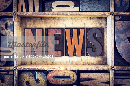 The word "News" written in vintage wooden letterpress type.