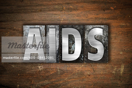 The word "AIDS" written in vintage metal letterpress type on an aged wooden background.