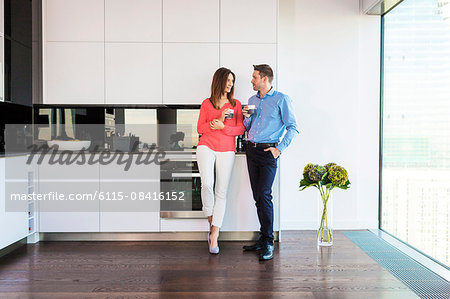 Couple in apartment having a coffee break