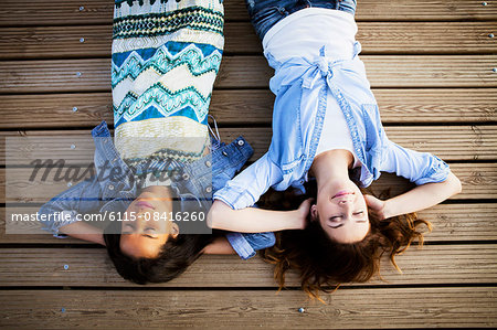 Two women lying on back with eyes closed