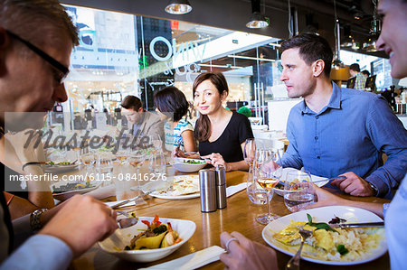 Group of friends celebrating in restaurant