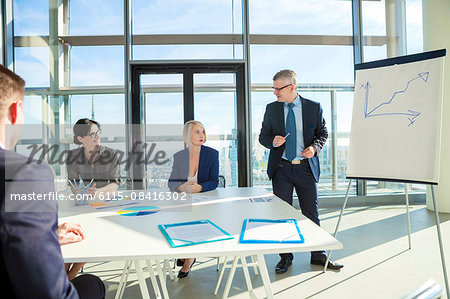 Senior architect giving presentation in business meeting