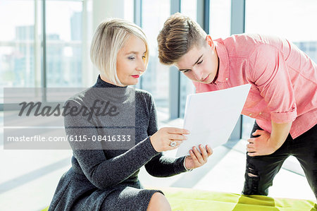 Female architect with trainee in modern office