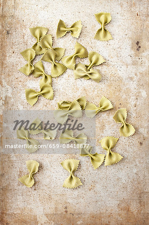 Spinach farfalle on metal surface