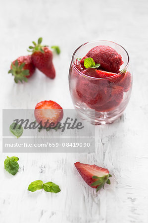 Strawberry sorbet with fresh mint in a glass