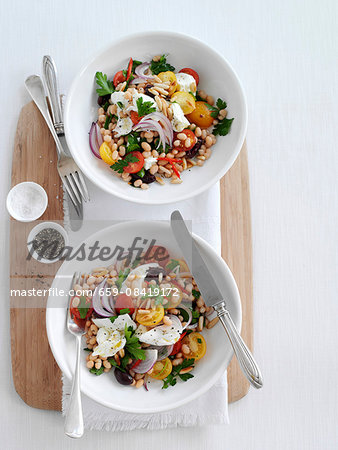 Bean salad with mozzarella, tomatoes, olives and onions (seen from above)