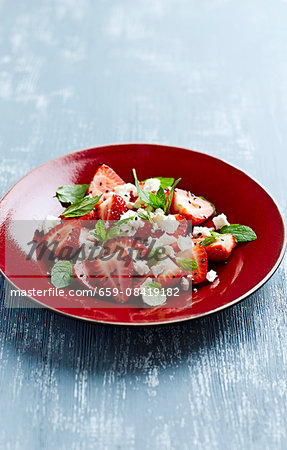 Strawberry salad with feta cheese, mint and black sesame seeds