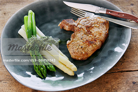 Pork chop with asparagus and coriander pesto