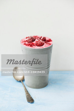 Homemade raspberry ice cream in a metal cup