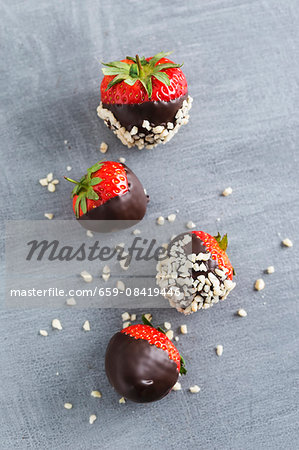 Chocolate-coated strawberries and chopped almonds