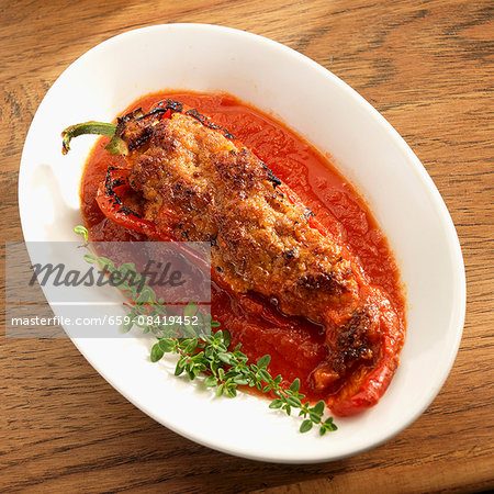 A stuffed, roasted Italian pepper with sausage, rice and cheese