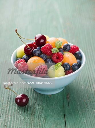 Fruit salad with berries, melon balls and cherries