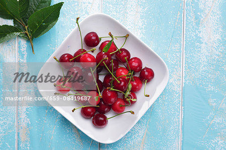 Fresh cherries on a plate (seen above)