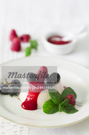 Panna cotta with fresh raspberry sauce and red grapes Panna cotta with fresh raspberry sauce and red grapes