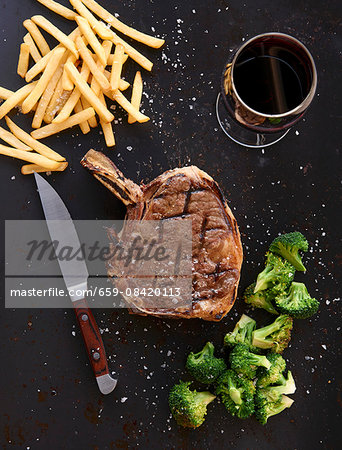 Prime rib steak with fries and broccoli