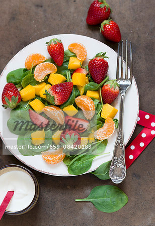 Spinach salad with fresh fruits (seen from above)