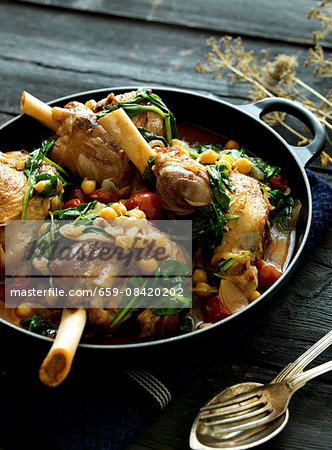 Knuckle of lamb in a curry sauce with spinach and chickpeas