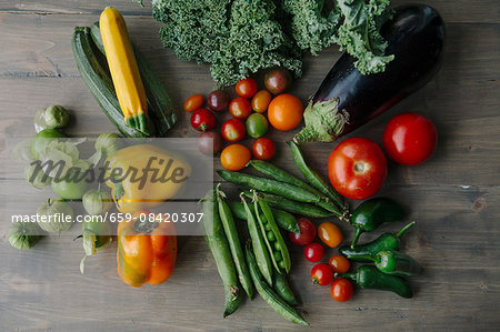 Assorted types of vegetables on a wooden surface Assorted types of vegetables on a wooden surface