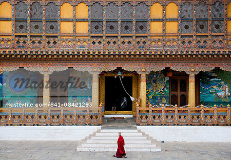 Monk walking through Punakha Dzong, Punakha District, Bhutan, Asia