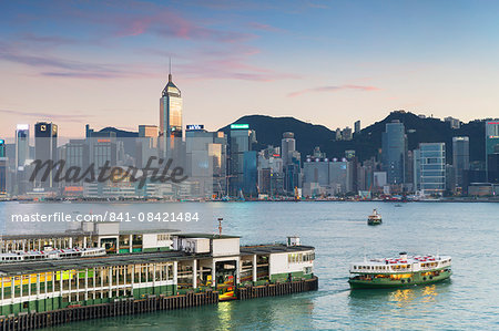 View of Star Ferry Terminal and Hong Kong Island skyline at dusk, Hong Kong, China, Asia