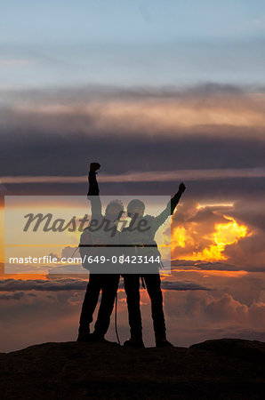 Climbers exulting on mountain top at sunset, Mont Blanc, France