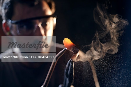 Close up of blacksmith shaping iron with blowtorch