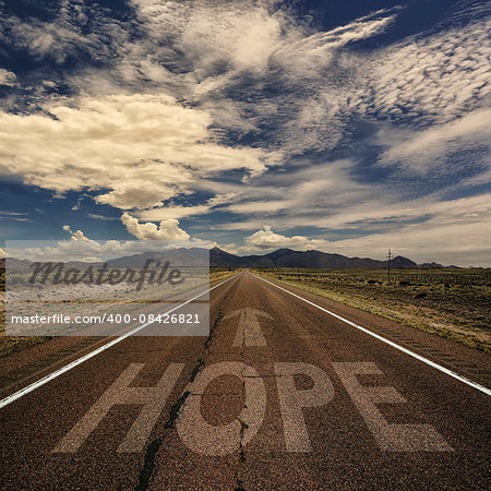 Conceptual image of desert road with the word hope and arrow