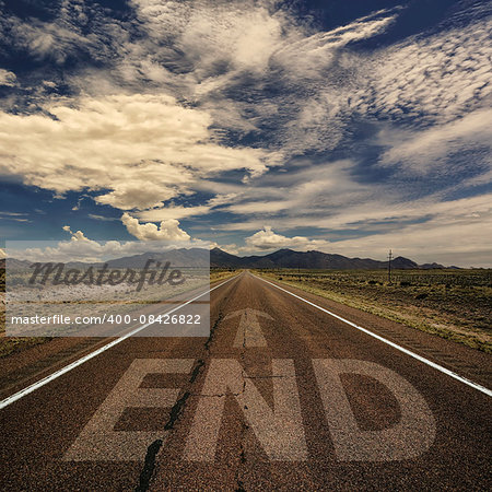 Conceptual image of desert road with the word end and arrow